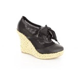 Andres Machado   Black laced shoes with jute wedge heel. Very 