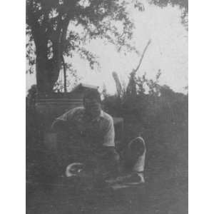  Two African American men, squatting, Eatonville 
