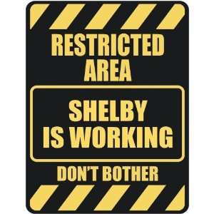   RESTRICTED AREA SHELBY IS WORKING  PARKING SIGN