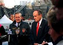 Rumsfeld and New York Mayor Rudy Giuliani speak at the site of the 
